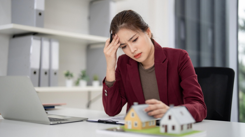 stressed real estate agent dealing with problems paperwork phone late night
